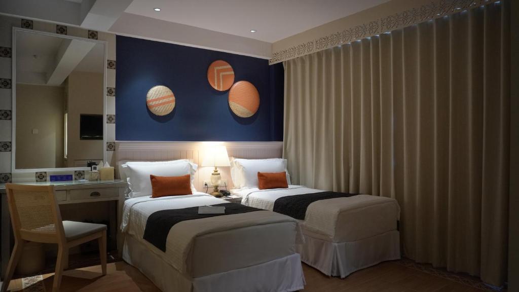 Postel nebo postele na pokoji v ubytování Sojourn Spa Hotel Melaka