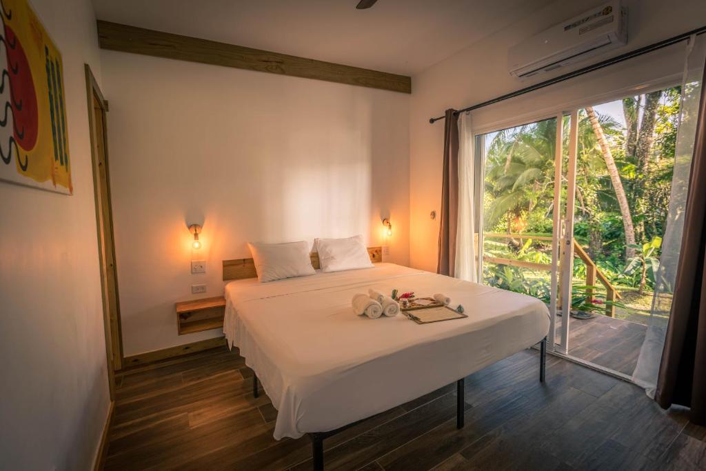 Un dormitorio con una cama y una ventana grande en Somewhere, en Bocas Town