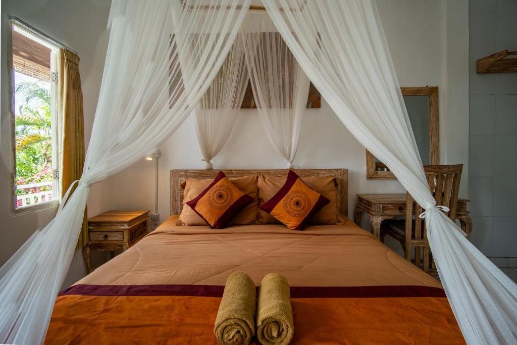 Postel nebo postele na pokoji v ubytování Kubu Sari Ubud