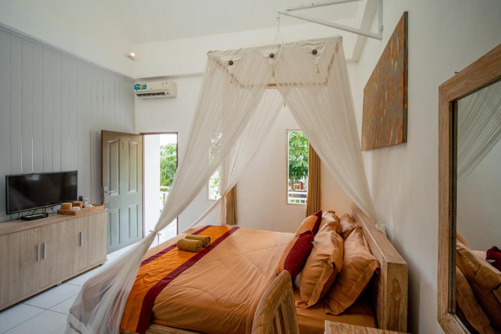 Postel nebo postele na pokoji v ubytování Kubu Sari Ubud