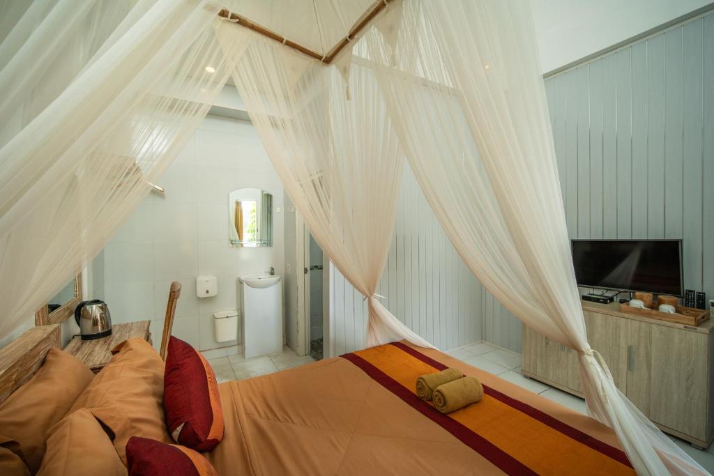 Postel nebo postele na pokoji v ubytování Kubu Sari Ubud
