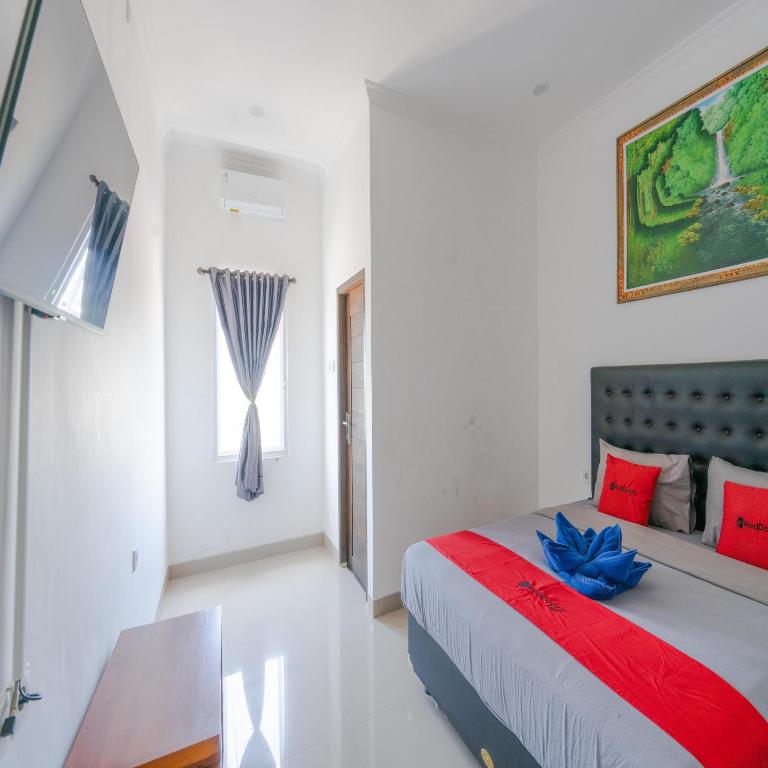Postel nebo postele na pokoji v ubytování RedDoorz @ Uluwatu Suites