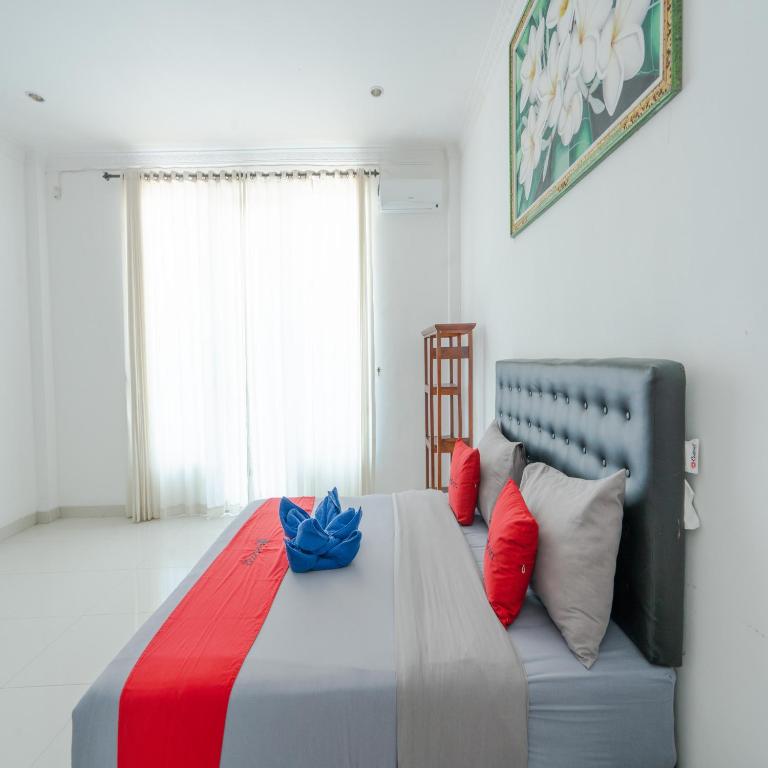 Postel nebo postele na pokoji v ubytování RedDoorz @ Uluwatu Suites