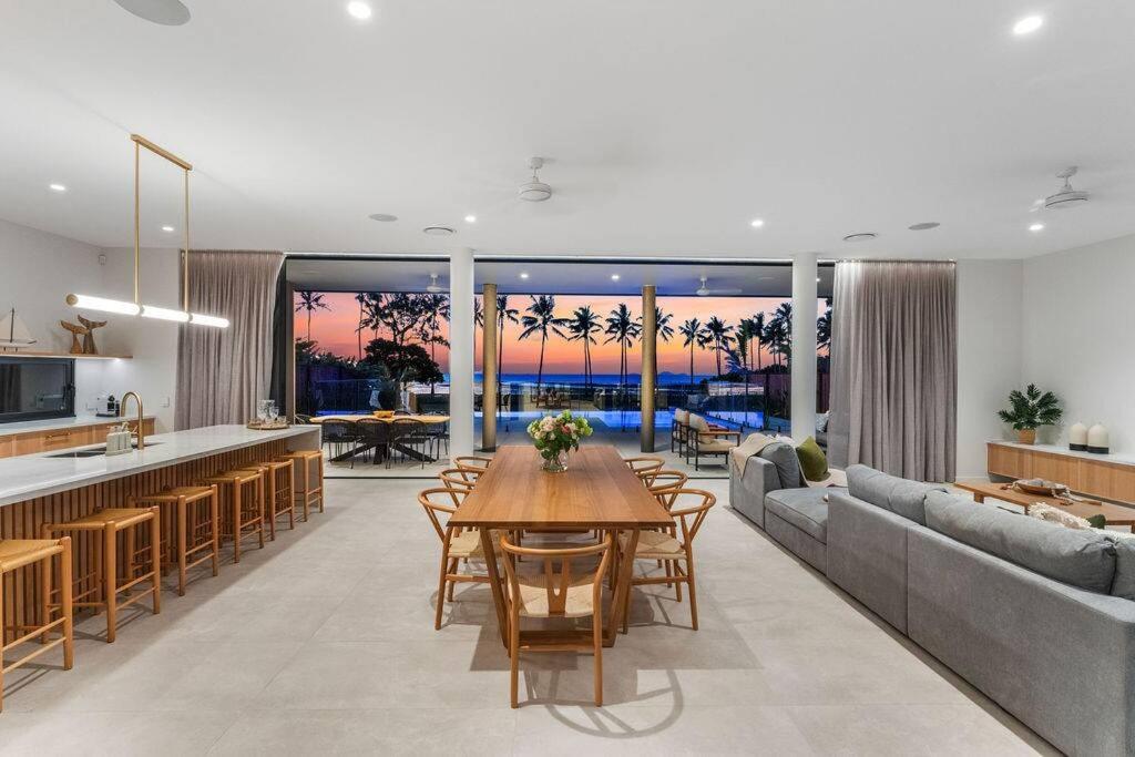 a kitchen and living room with a table and a couch at Jasper in Airlie Beach