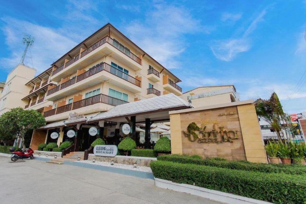 a building with a sign in front of it at Sarita Chalet & Spa Jomtien beach Pattaya in Jomtien Beach