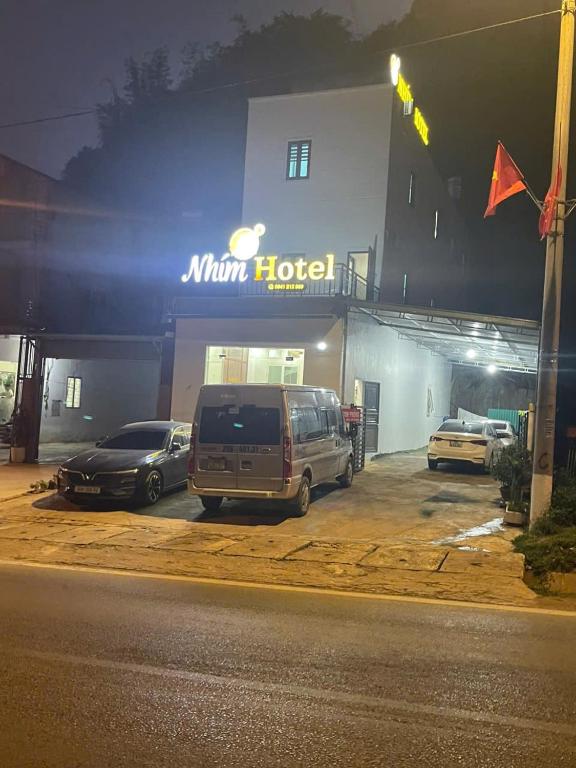 a minivan parked in front of a hotel at night at Nhím Hotel MC - by BAY LUXURY in Mộc Châu