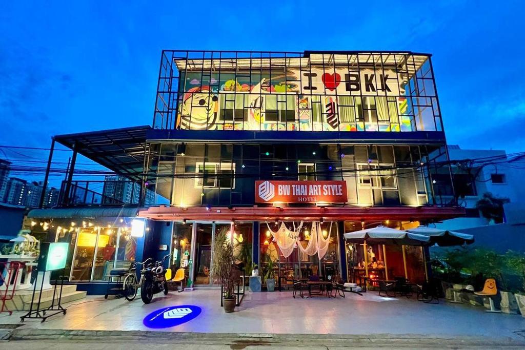 a building with a restaurant on top of it at BW Thai Art Style Hotel in Bangkok