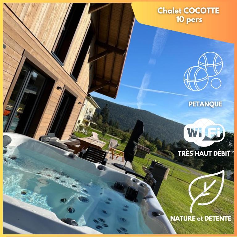 une baignoire jacuzzi en face d'une maison dans l'établissement Chalet COCOTTE - pétanque, jacuzzi & baby-foot, à Xonrupt-Longemer
