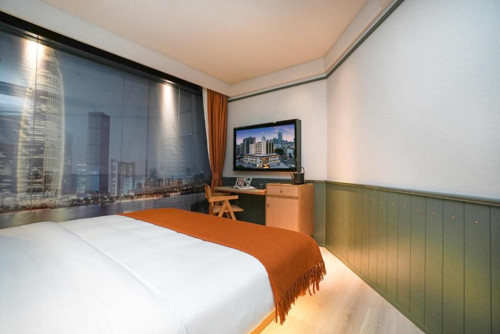 Postel nebo postele na pokoji v ubytování Shenzhen Xili Ruixi Hotel