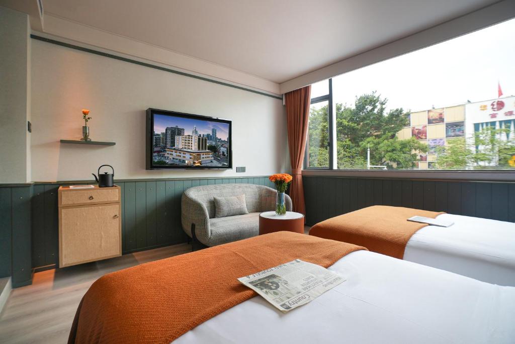 Postel nebo postele na pokoji v ubytování Shenzhen Xili Ruixi Hotel