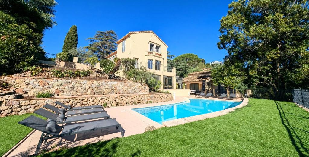 une maison avec une piscine dans une cour dans l'établissement Ref VCLAIR by Palmes dProperties, à Cannes