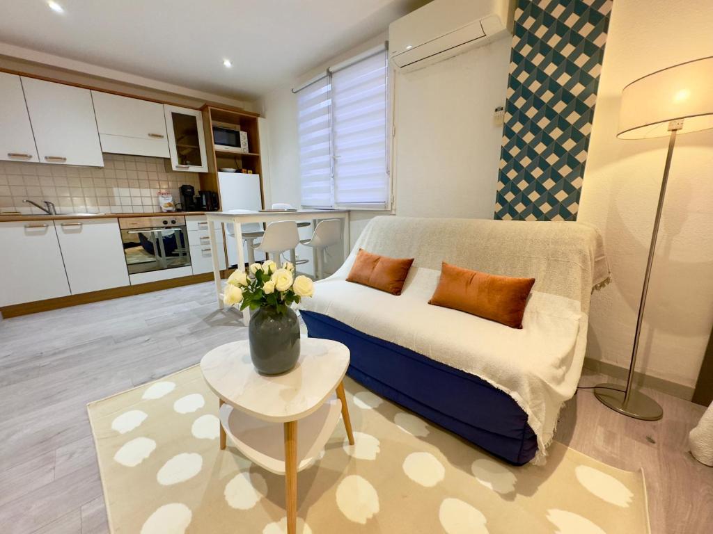 un salon avec un canapé et une table dans l'établissement Grand studio confortable au coeur de Cannes, à Cannes