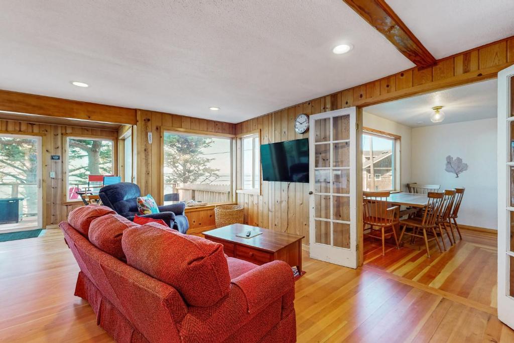 a living room with a red couch and a table at Carolyn's Dream in Oceanside