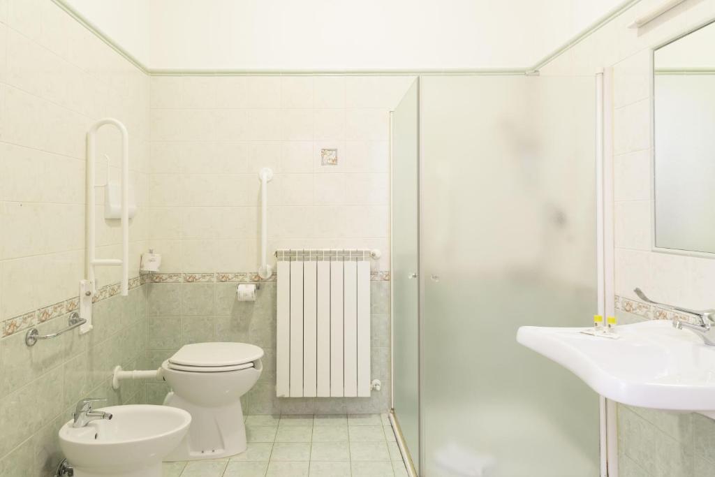 a white bathroom with a toilet and a sink at B&B Hotel Pescara in Pescara