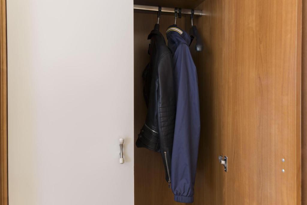 a closet with an umbrella hanging from a door at B&B Hotel Pescara in Pescara