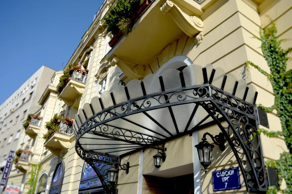 a building with an iron gate on the side of it at Belgrade City Hotel in Belgrade
