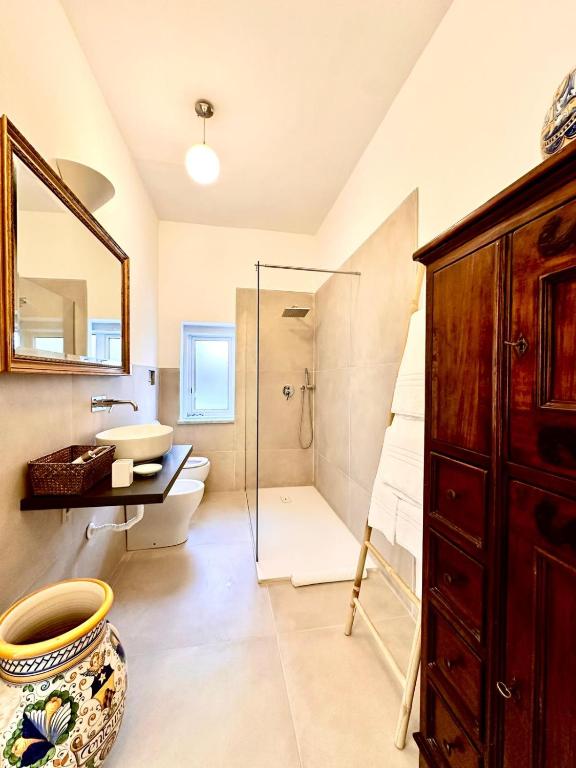 a bathroom with a sink and a toilet and a shower at Domus Orestea Luxury Suites in Palermo