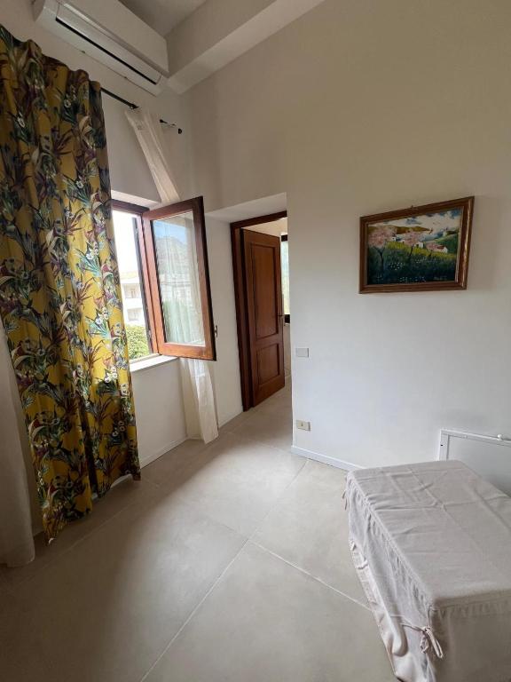 a bedroom with a bed and a painting on the wall at Domus Orestea Luxury Suites in Palermo