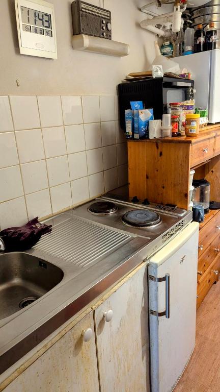 Il comprend une cuisine équipée d'une cuisinière et d'un évier. dans l'établissement Studio Paris, ground floor, à Asnières-sur-Seine