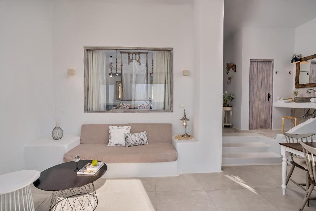 a living room with a couch and a table at Althea Boutique Hotel - Adults Only in Amoopi