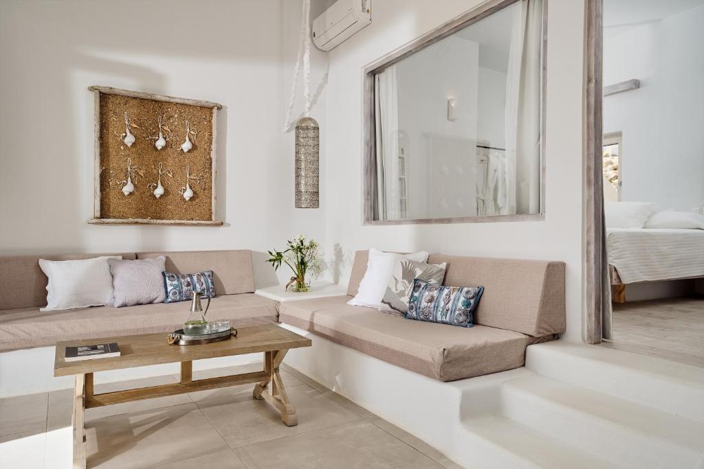 a living room with a couch and a table at Althea Boutique Hotel - Adults Only in Amoopi
