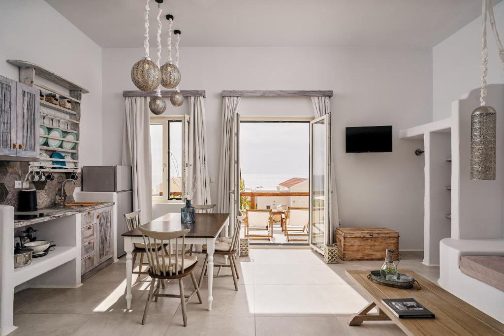 a kitchen with a table and chairs and a dining room at Althea Boutique Hotel - Adults Only in Amoopi