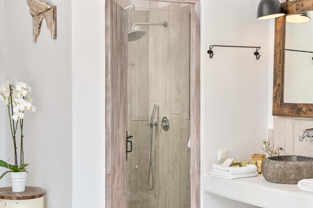 a shower with a glass door in a bathroom at Althea Boutique Hotel - Adults Only in Amoopi