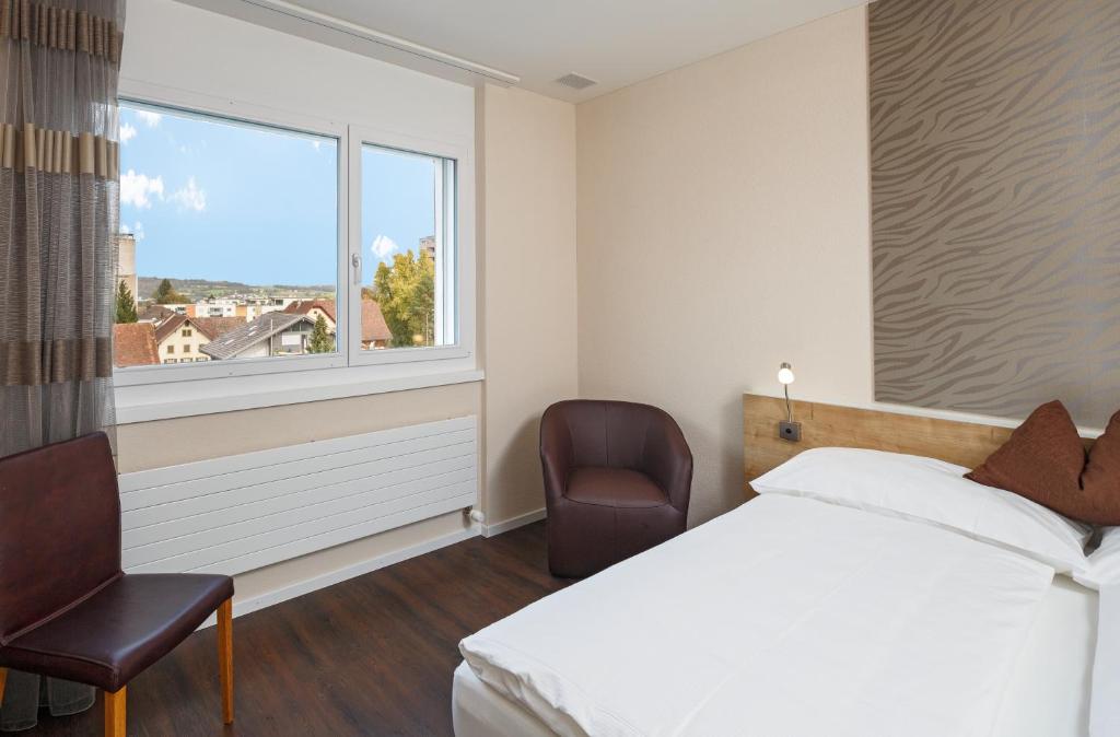 Postel nebo postele na pokoji v ubytování Villmergen Swiss Quality Hotel