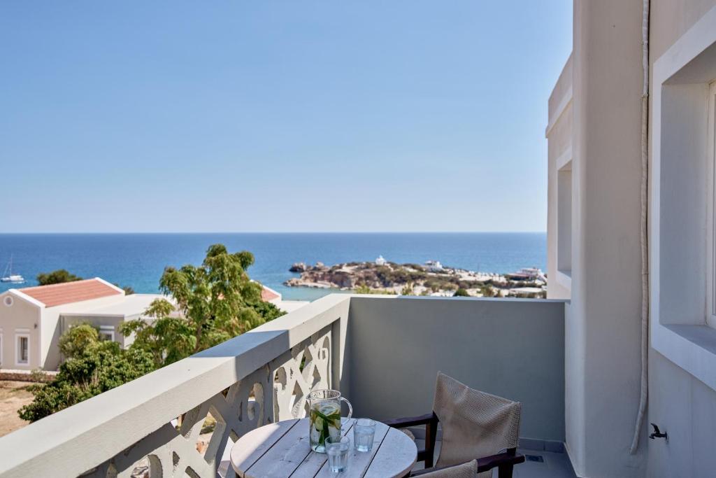 a balcony with a table and a view of the ocean at Althea Boutique Hotel - Adults Only in Amoopi