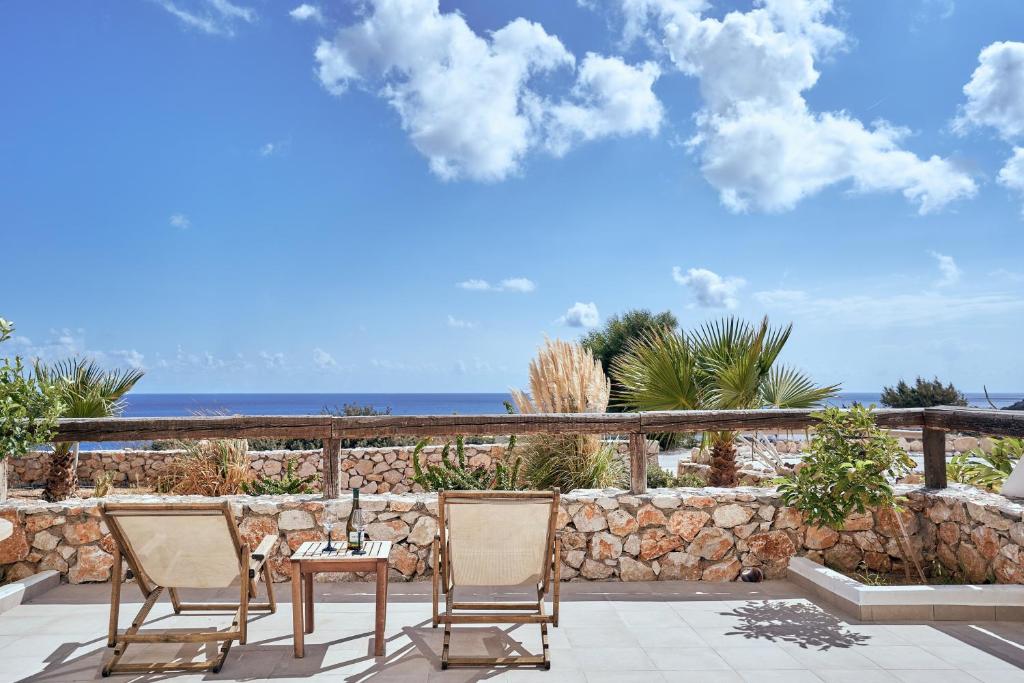 a patio with a table and chairs and the ocean at Althea Boutique Hotel - Adults Only in Amoopi