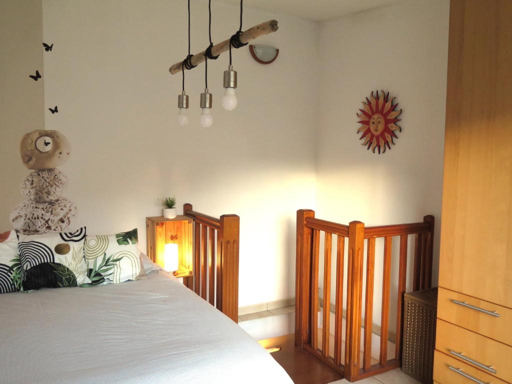 a bedroom with a bed and a clock on the wall at Maison de village à 35 m du bord de mer in Marseille