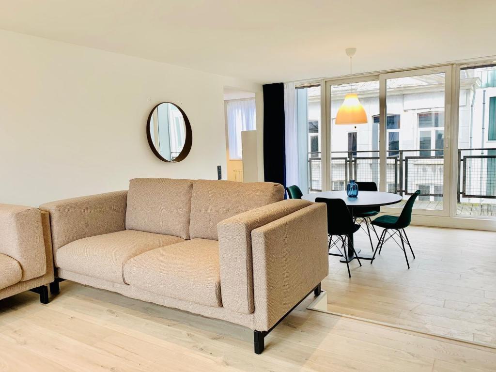 a living room with a couch and a table at Belfort Shortstay in Ghent