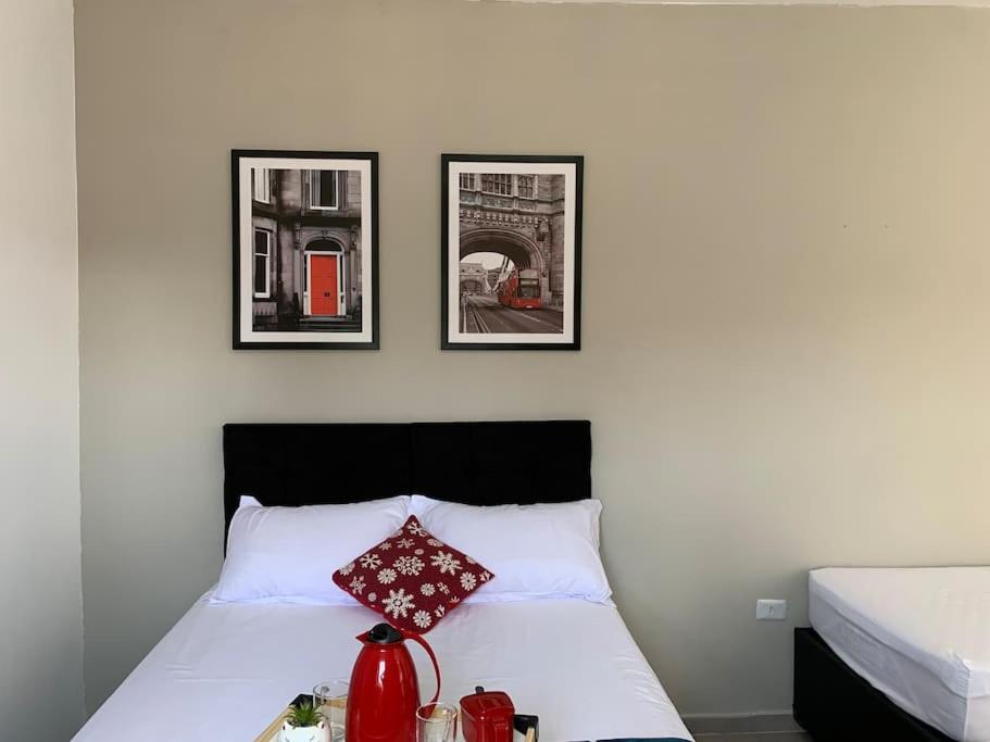 a bedroom with a bed with three pictures on the wall at Studio 21 Fácil acesso Aeroporto Internacional Guarulhos e Arena Corinthians in Sao Paulo