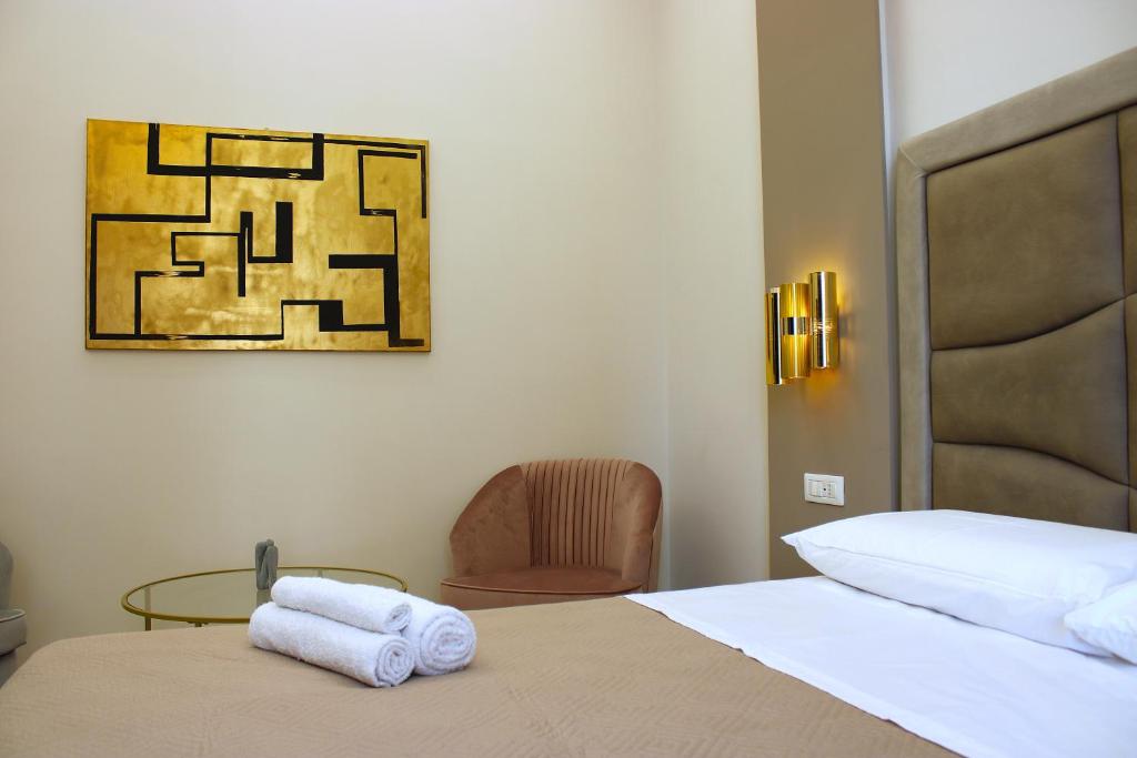 Postel nebo postele na pokoji v ubytování InCentro Elegant Rooms