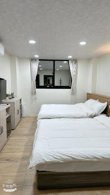 Postel nebo postele na pokoji v ubytování Fulong City B&B