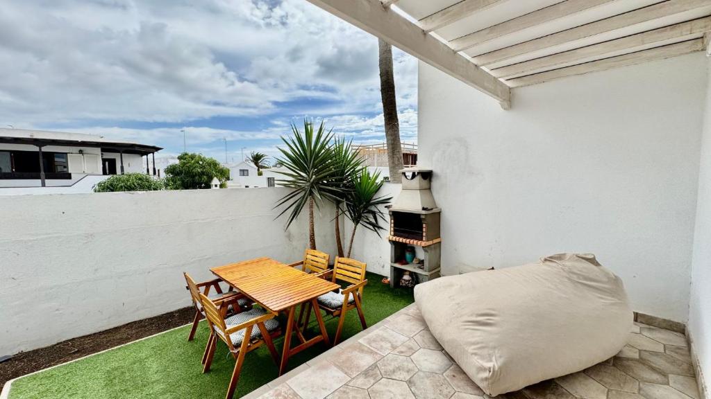a patio with a table and chairs and a grill at Le Family Palms Private Oasis with Terrace & BBQ in Playa Honda