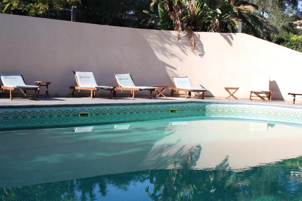 a group of chairs sitting next to a swimming pool at Résidence Fior di Rena in Saint-Florent