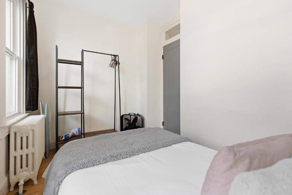 a bedroom with a white bed and a window at H St DC Haven 4-BR Homestay in Washington, D.C.