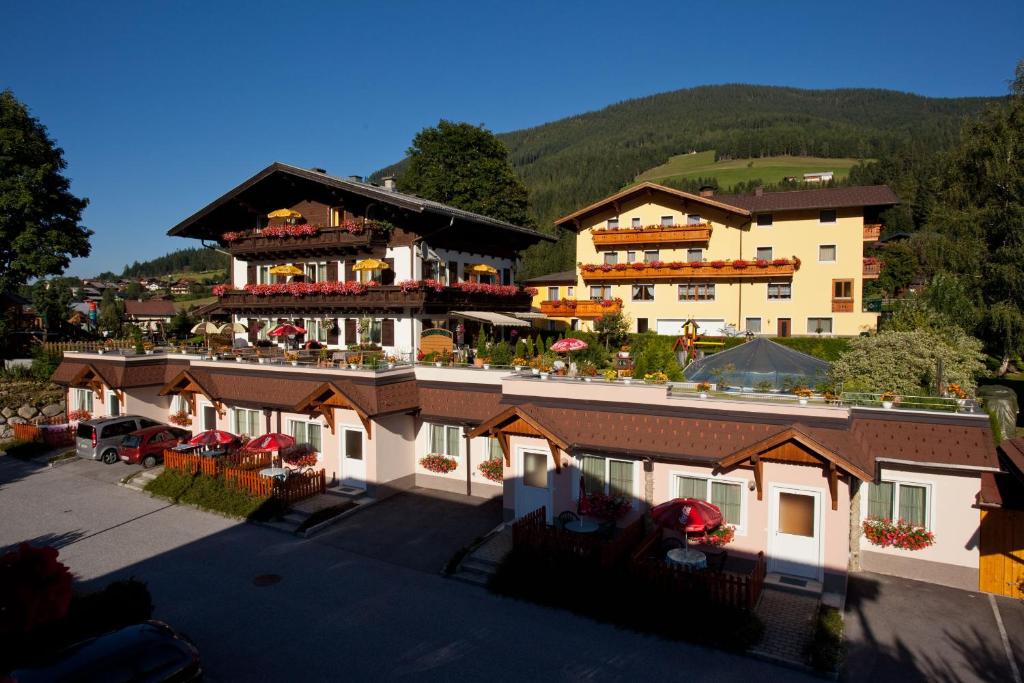 an aerial view of a hotel with mountains in the background at Familiengästehaus Ingrid in Sankt Martin am Tennengebirge