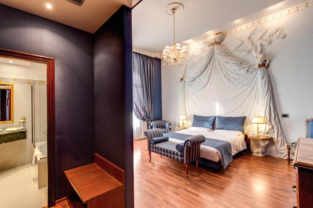 Postel nebo postele na pokoji v ubytování Hotel Impero