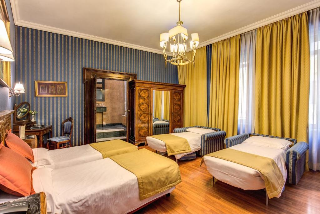 Postel nebo postele na pokoji v ubytování Hotel Impero