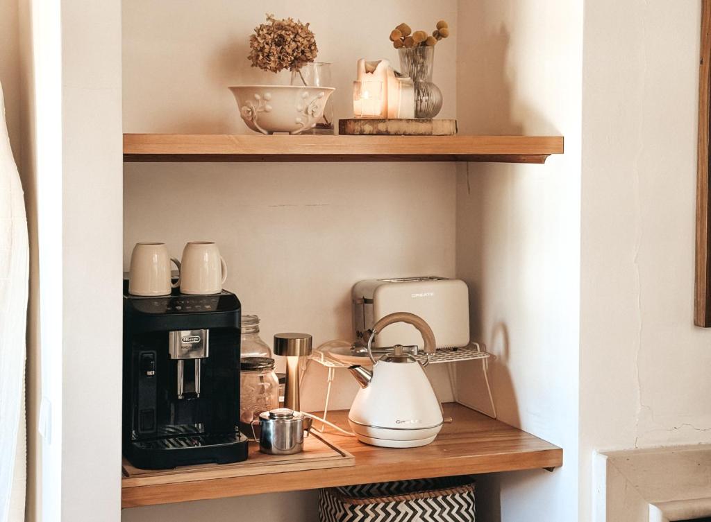 a shelf with a coffee maker and appliances on it at Quinta Amarela - B&B in Nazaré