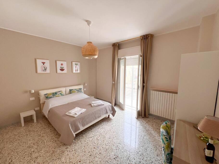 a bedroom with a bed and a large window at Anna Luxury Apartment in Bisceglie