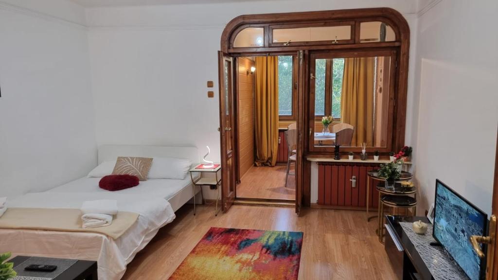 a small room with a bed and a mirror at Feeria National Parc in Bucharest