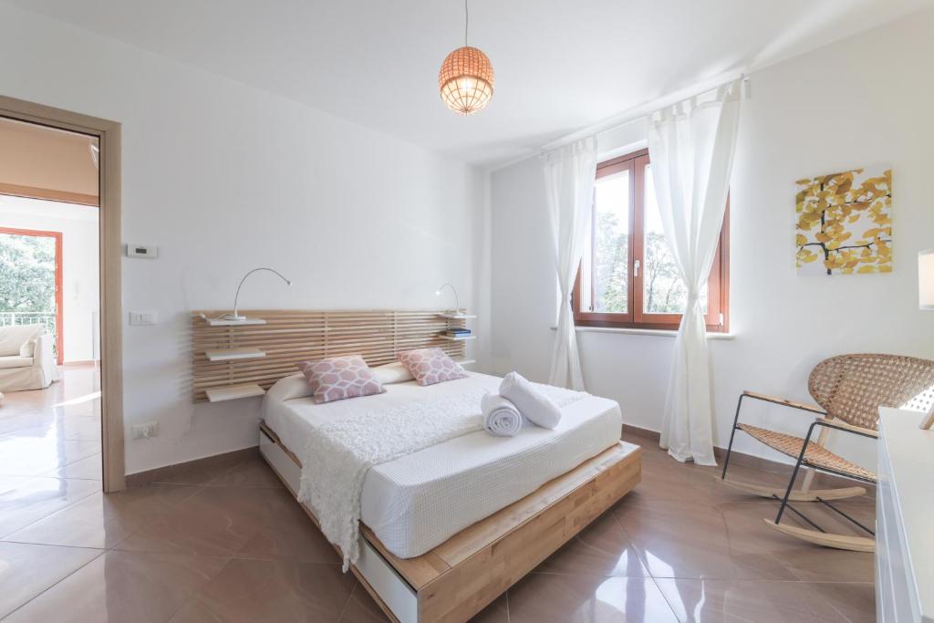 Postel nebo postele na pokoji v ubytování Appartamenti Orchidea e Glicine