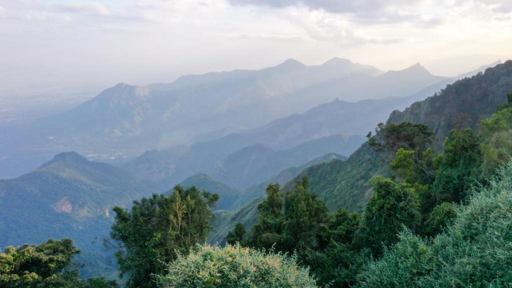 a view of a valley with mountains in the background at HappyHuts at Green valley view in Kodaikānāl