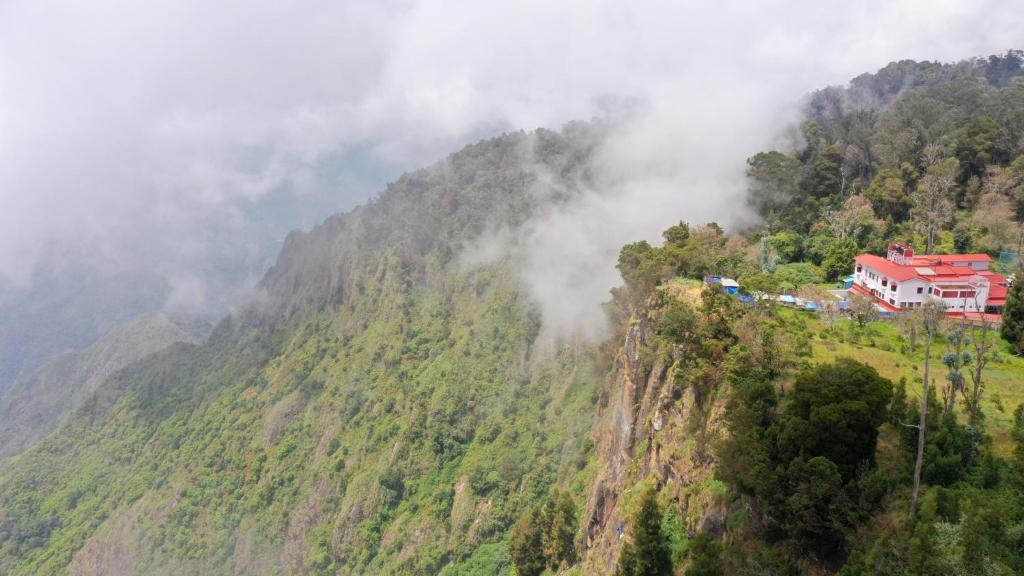 a house on the side of a mountain at HappyHuts at Green valley view in Kodaikānāl