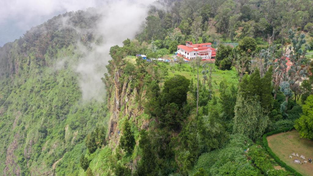 a house on the side of a mountain at HappyHuts at Green valley view in Kodaikānāl