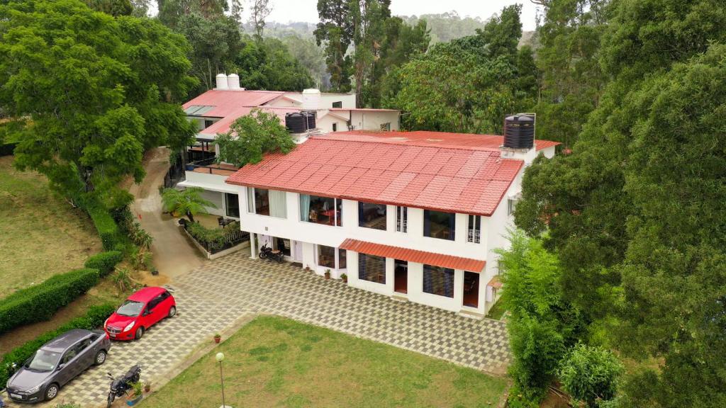an aerial view of a house with a red roof at HappyHuts at Green valley view in Kodaikānāl