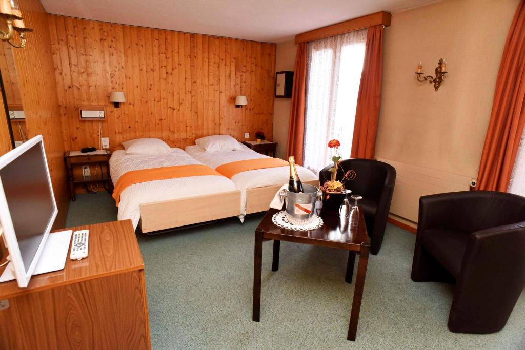 Postel nebo postele na pokoji v ubytování Hotel de la Poste Verbier